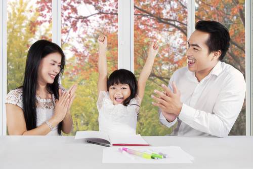 Parents giving applause on their daughter